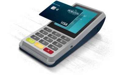 Picture of a Horizon card being used with a tap to pay style card reader.