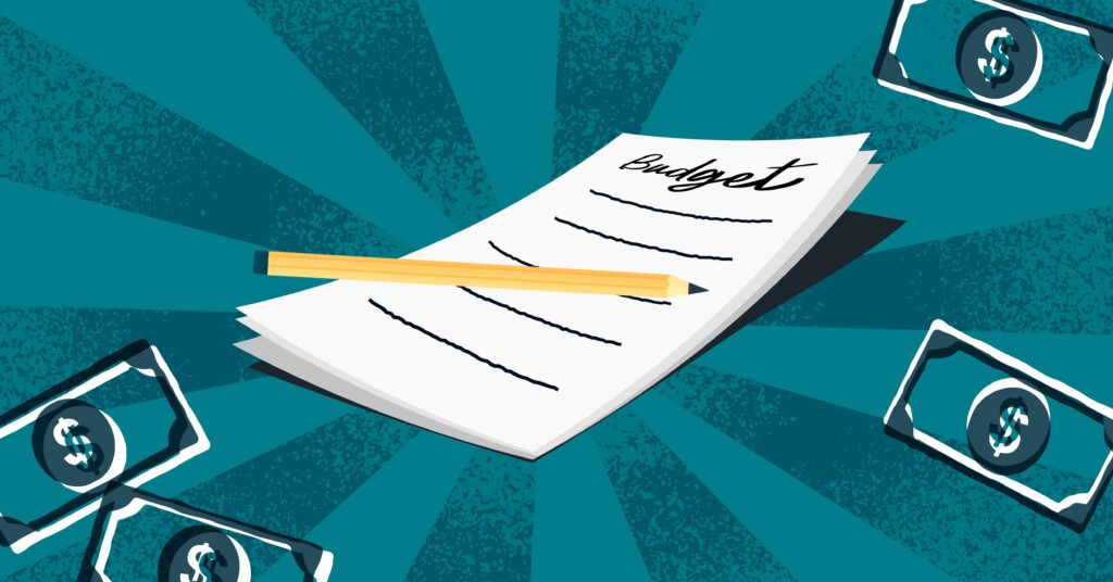 a notepad that says "budget" with a pencil laying on it