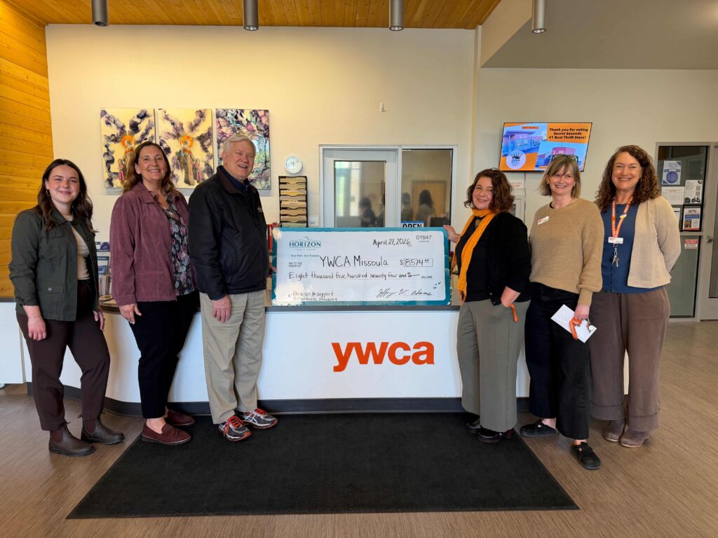 Horizon Credit Union employees presenting a big check with $8,574 to YWCA Missoula employees. 